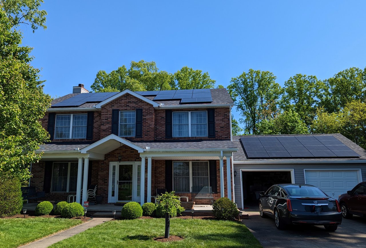 Solar panels on a brick colonial home and attached garage